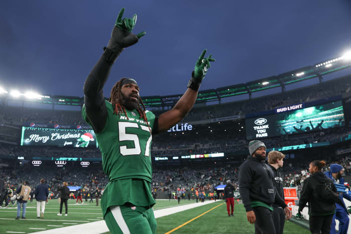 C.J. Mosley walks off the field with both arms up in celebration